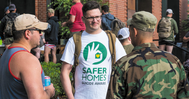 Forefront Program Coordinator Brett Bass joins fellow veterans to build awareness about the Save Homes, Suicide Aware program. Photo of Brett talking to two veterans.