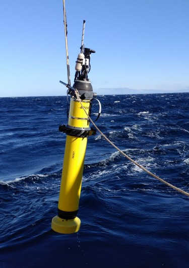 A drifting robot known as an Electro-Magnetic Autonomous Profiling Explorer, or EM-APEX, is lowered into the ocean. This is one of four floats that traveled with currents under the Dotson Ice Shelf.