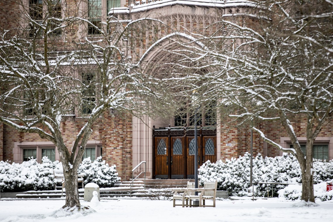 brick building with snowy trees