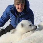 Laidre in blue parka with polar bear cubs