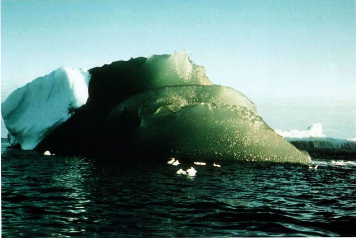 green iceberg on blue background