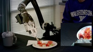 The robot skewers a strawberry