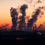 industry smokestacks at sunrise