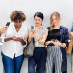 A group of people looking at their phones