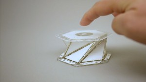 a hand pointing to the paper model