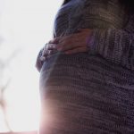 pregnant woman holding belly