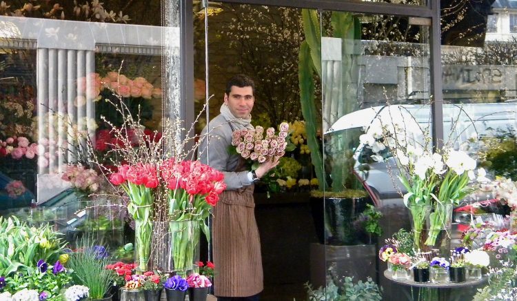 Florist displaying flower arrangement 