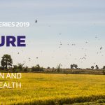 Future of food banner. Purple text over a picture of people harvesting rice
