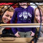 students gathering around a 3D printer