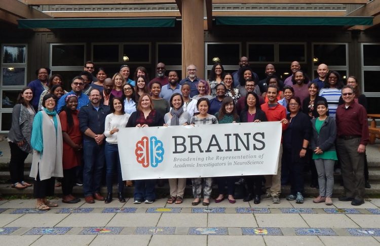 The 2019 cohort for the BRAINS program, or Broadening the Representations of Academic Investigators in NeuroScience. Program evaluator Cara Margherio is in the back row, two people to the left of the post. Co-director Claire Horner-Devine is at the far right. Laura Ciotto , program operations, is at the far left. Co-director Joyce Yen is at the far left, middle row. Director Sheri Mizumori is fifth from the right in the front row.