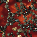 shiny black balls on red background