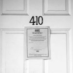 Photo of closed door with eviction notice on the front