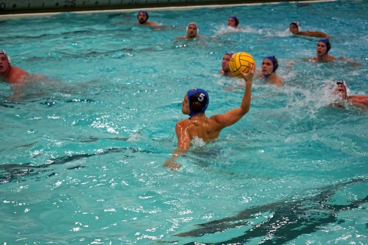 A person playing water polo -- about to throw the ball