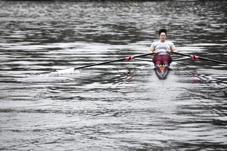 A person rows on a lake