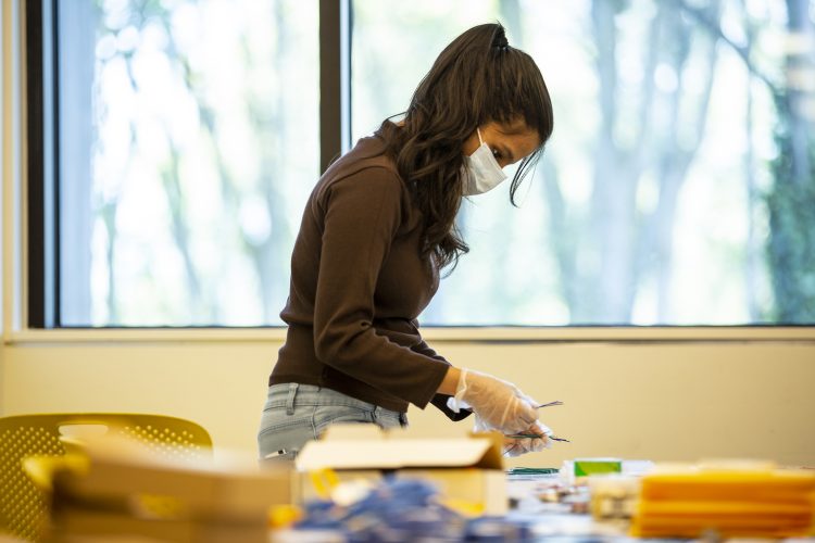 A TA preparing a kit to send home to students