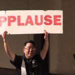 Curtis Takahashi reminds the audience to applaud in a Seattle Radio Theater production of "The Bishop's Wife" at Town Hall Seattle, broadcast by KIRO TV.