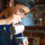Barista making latte