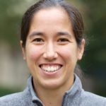 A person standing smiling at the camera