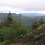 bare slope and mountains in distance