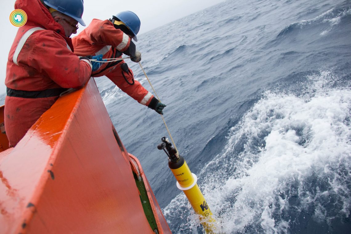 two people drop instrument in water