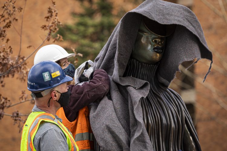 Workers with sculpture