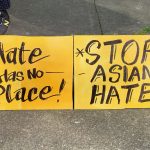 Signs read "hate has no place" and "stop Asian hate"