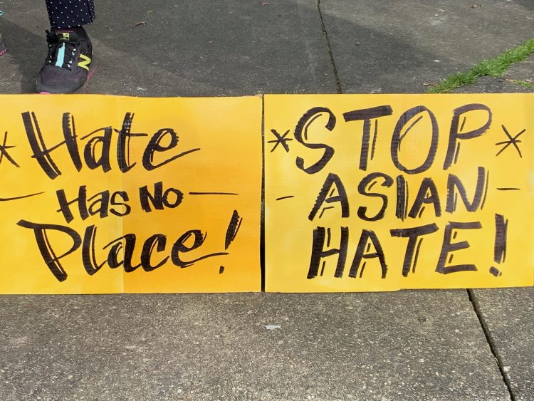 Signs read "hate has no place" and "stop Asian hate"