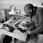 Jacob Lawrence painting in his studio