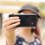 A person holding a phone in front of their face