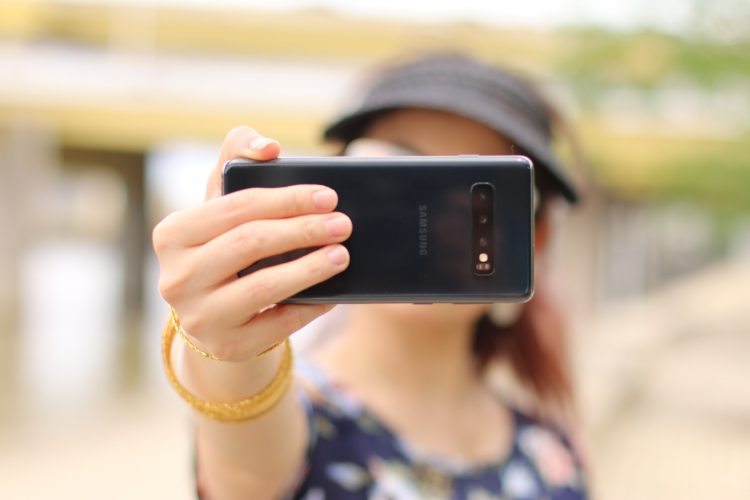 A person holding a phone in front of their face