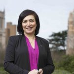Dean Azita Emami on the UW campus with Gerberding and Mary Gates Halls in the background.