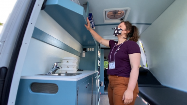 Student volunteer Nina Cook shows off features of the new mobile health outreach van.