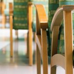 A row of green chairs in a waiting room