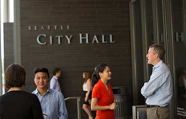 People converse outside City Hall