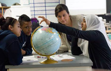 Students studying a globe