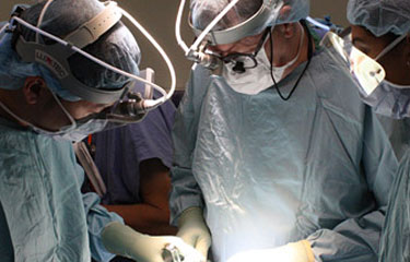 Two surgeons operating on a patient