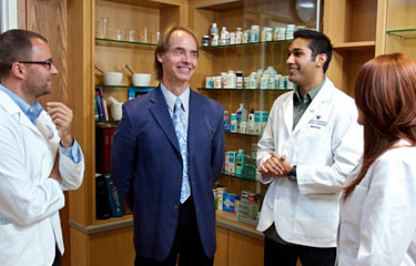 A professor lecturing students in a pharmacy