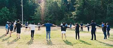 International Domestic Students Holding Hands in a Circle