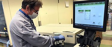 Researcher looks at data on a computer screen