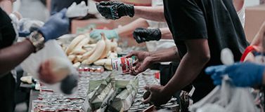 Workers sort goods at a table
