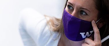 Person wears a purple face mask with W logo