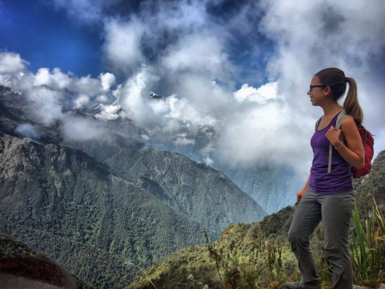 UW graduate Sheri Imsdahl on a ridge overlooking a valley.