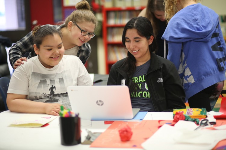 The healthcare group was led by UW freshman Victoria Jackson, who plans on studying history. Here, she and her fifth-graders review their footage.