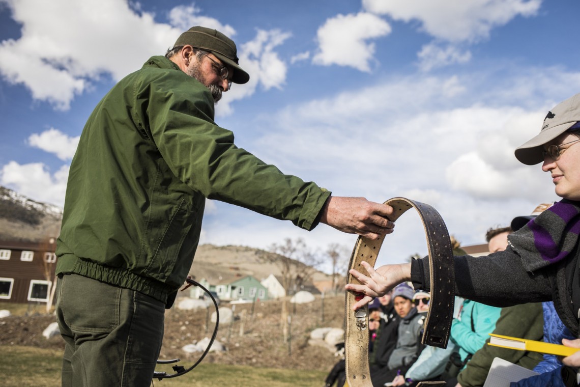 Rick Wallen, lead biologist for bison in Yellowstone, shares with students a collar used to monitor bison in the park.