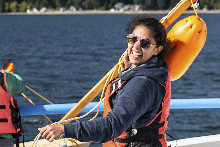Deana Crouser on a deck of a boat, smiling in the sunlight