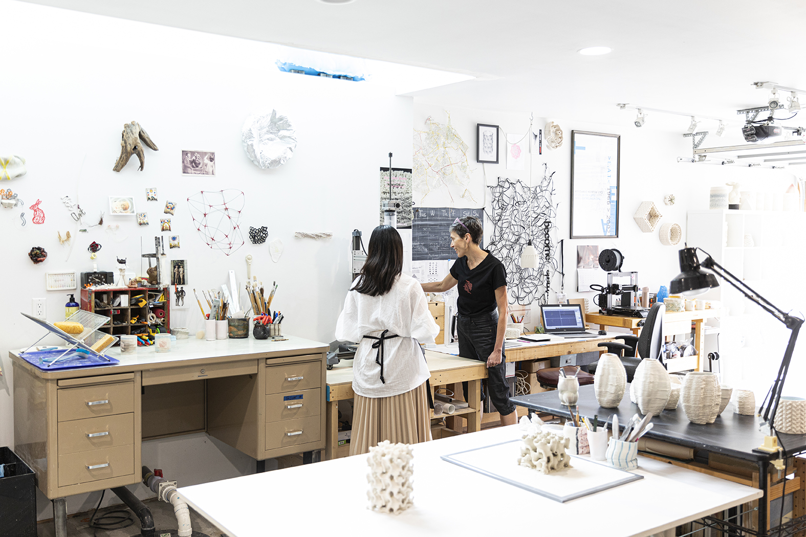 Timea Tihanyi collaborates with Wanna Huang, ’18, to craft 3D-printed porcelain artworks. Tihanyi, a senior lecturer in the UW School of Art + Art History + Design, invites student interns from a variety of disciplines to explore the possibilities of 3D-printing technology. (Photo by Mark Stone)