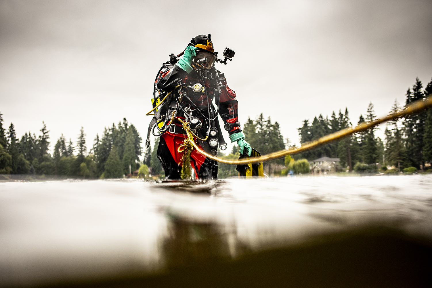 An EPA diver deploys instruments in Lake Killarney, where a team of UW researchers is exploring how arsenic travels from the lakebed to the food web. (Photo by Dennis Wise)