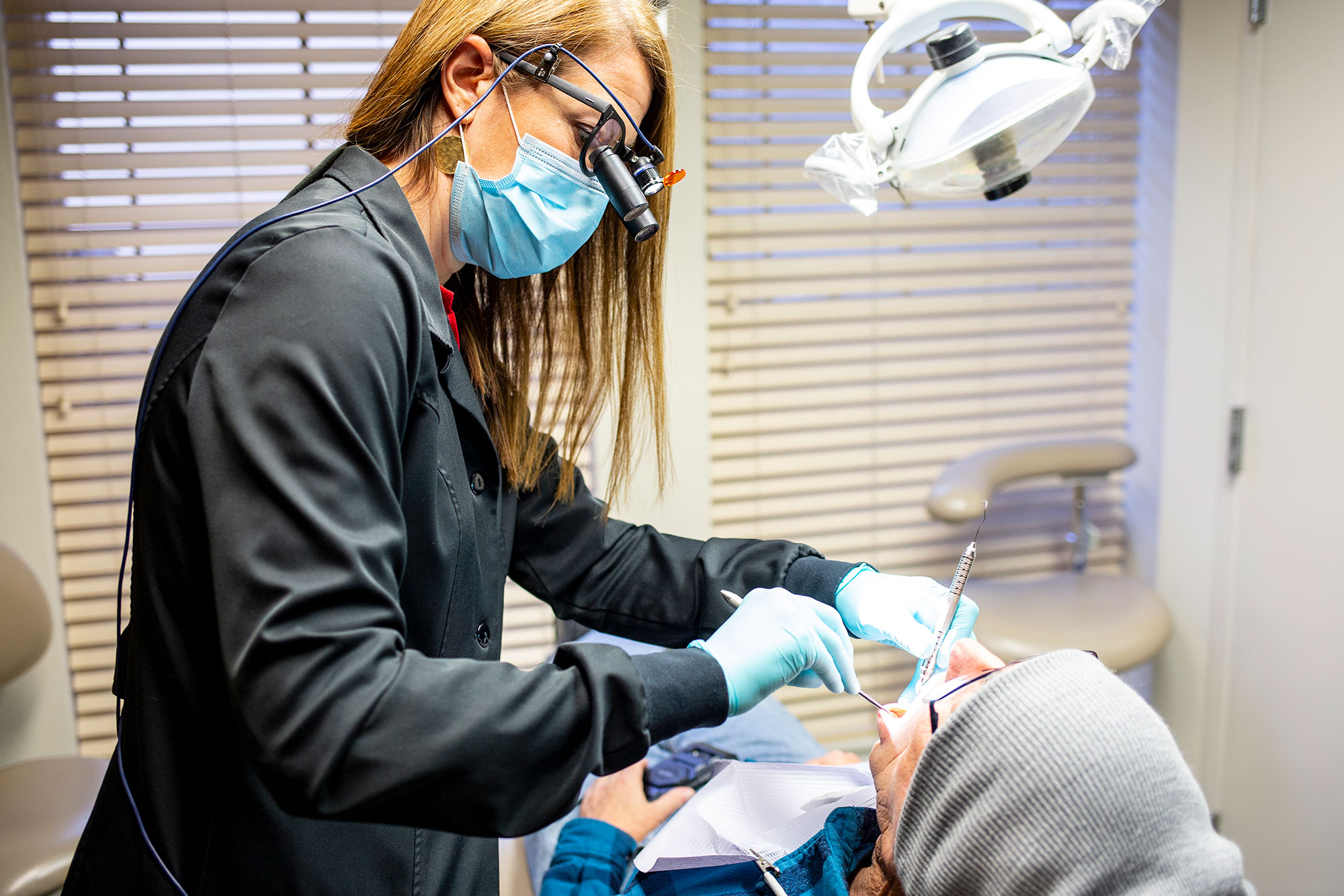 Dr. Nikole O’Bryan, who volunteers her services through Everyone for Veterans, works on restoring veteran Ray Schmick’s teeth at her Seattle practice.