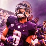 Football players with purple smoke