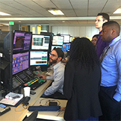 Students see a worker operate professional softwares